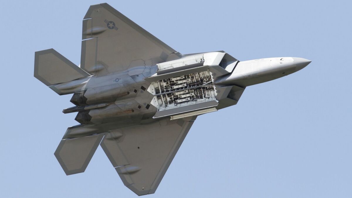 An Air Force F-22 Raptor displays its weapons bay as it's taken through maneuvers during a demonstration at Langley Air Force Base in Hampton, Va., on April 30, 2012.