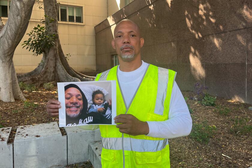Los Angeles, California-June 256, 2024-Montise Bulley holds a photo of him with his 1-year-old son Justin, who died in February of fentanyl. Bulley said the Los Angeles County Department of Children and Family Services failed to protect his son, who he said ingested the lethal does of the dangerous drug while on a supervised visit with his mother. "I don't care about the money -- I want my son," Bulley said. (Grace Toohey/Los Angeles Times)