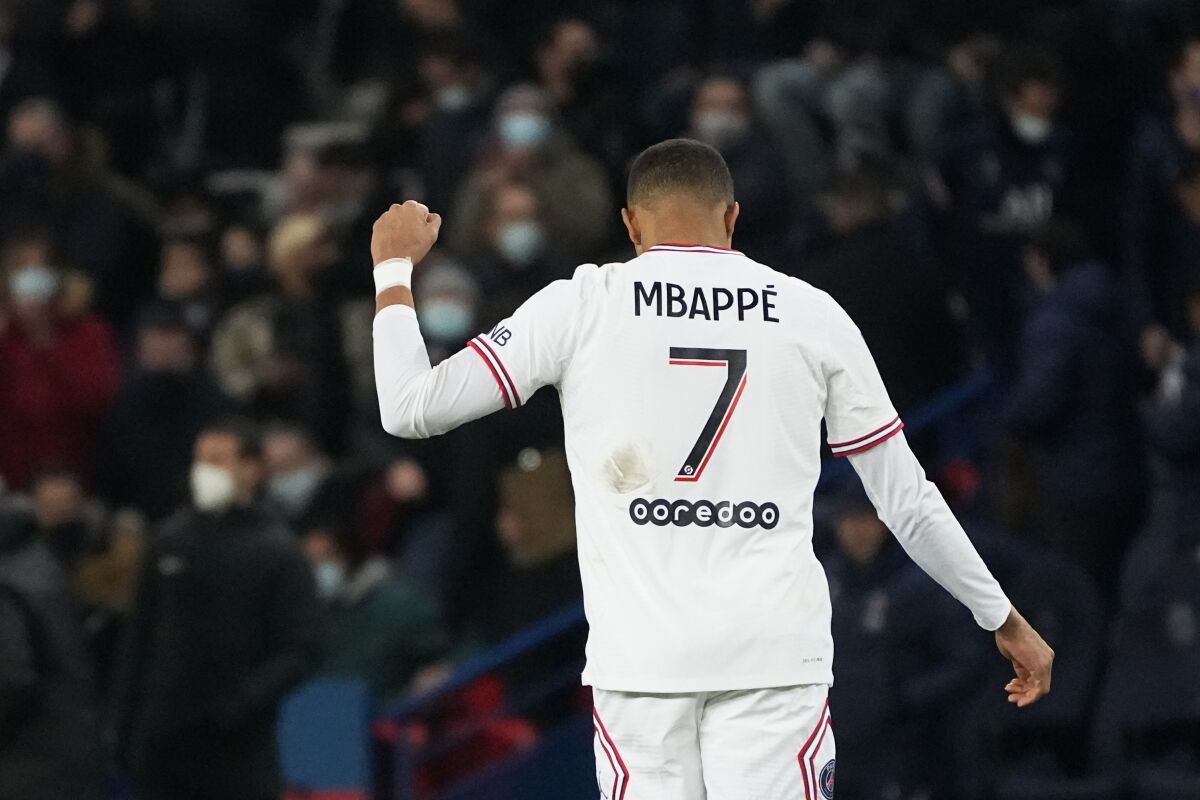 PSG's Kylian Mbappe celebrates after scoring his side's opening goal during the French League One soccer match between Paris Saint Germain and Rennes at the Parc des Princes stadium in Paris, Friday, Feb. 11, 2022. (AP Photo/Michel Euler)
