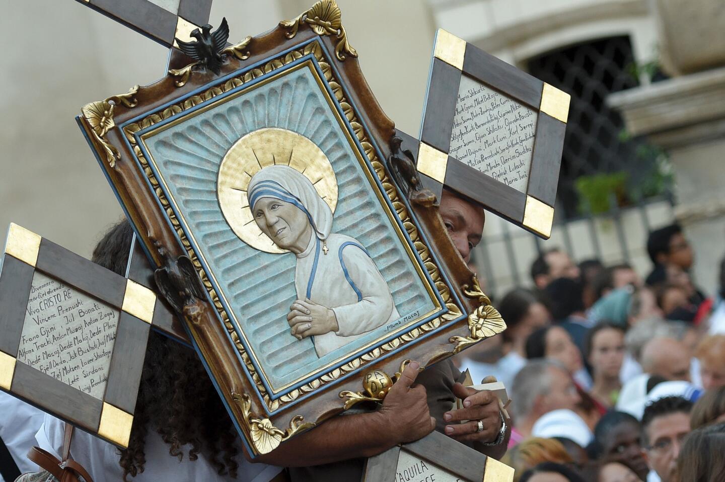 A man holds an icon of Mother Teresa of Kolkata as he arrives for the canonization in the Vatican.