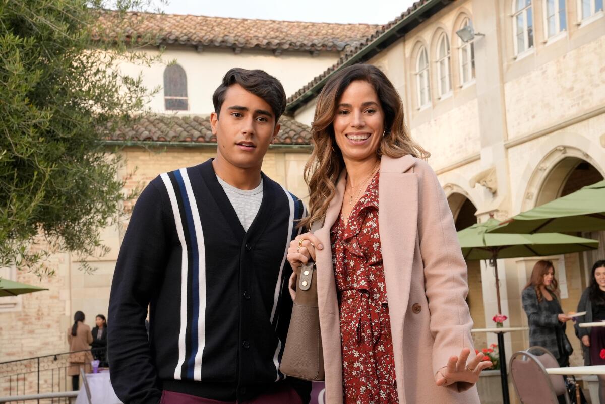 A teenage boy and his mother outside a church