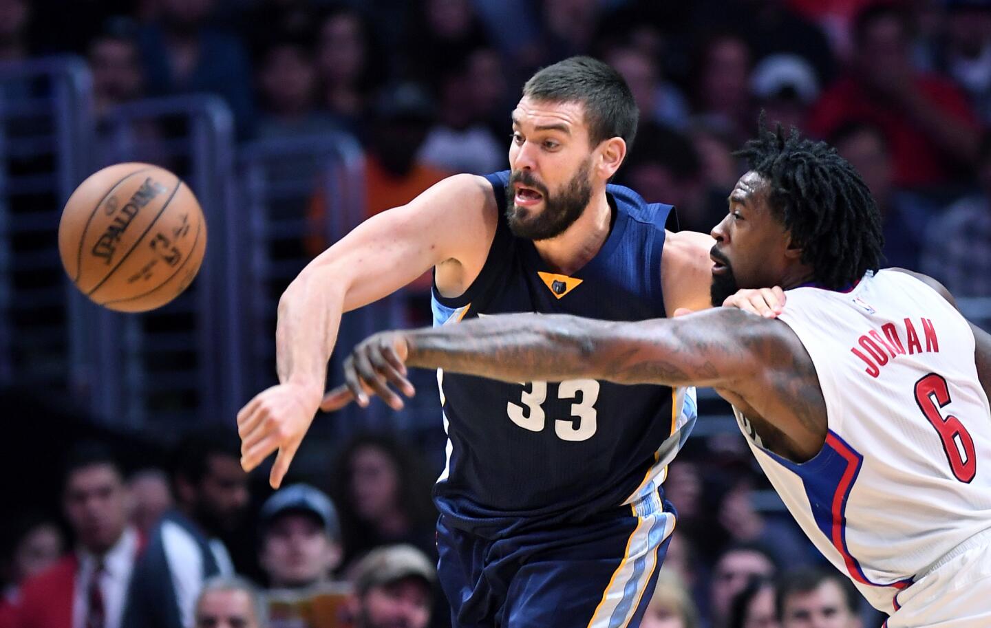 Clippers center DeAndre Jordan knocks the ball away from Grizzlies center Marc Gasol during their game Wednesday.