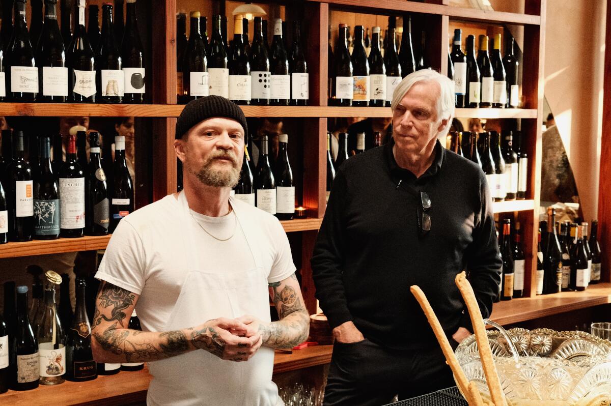 Chef Brian Dunsmoor stands at left, looking at camera, while Glenn Roberts, right, looks at him, in the bar of Dunsmoor.