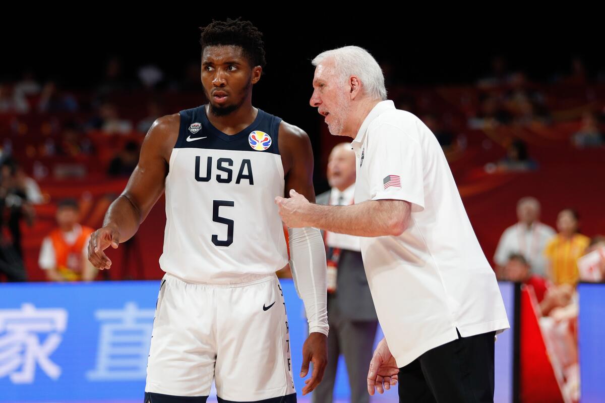 Team USA coach Gregg Popovich of USA speaks to Donovan Mitchell during the win over Poland at the FIBA World Cup on Saturday in Beijing.
