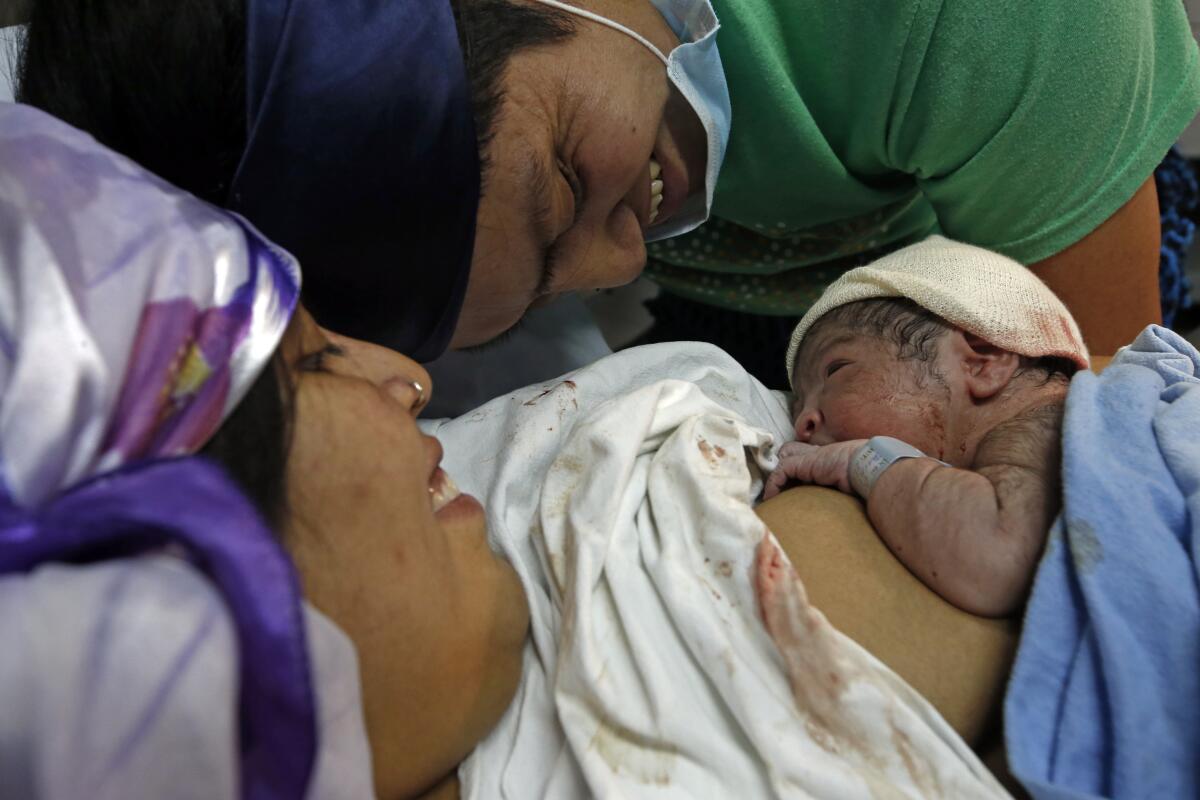 A couple look at their newborn son at a hospital in Chile.