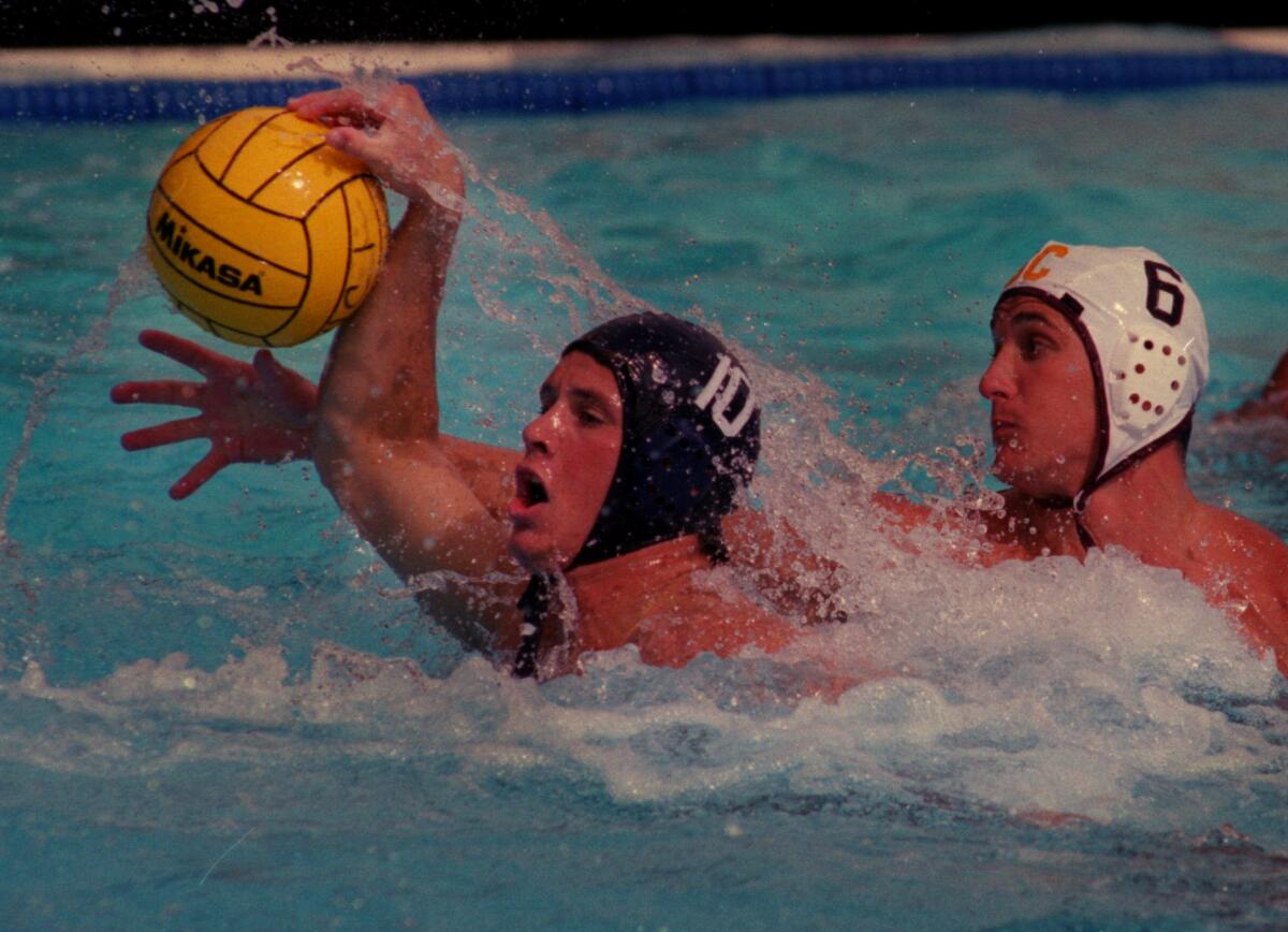 UCI's Andy Coffman (10) tries to maintain control of the ball against USC's Marko Pintaric. USC won the match 10-7 was held at a Irvine High School on Oct 24, 1998. Pintaric was a member of the 1998 national championship team.