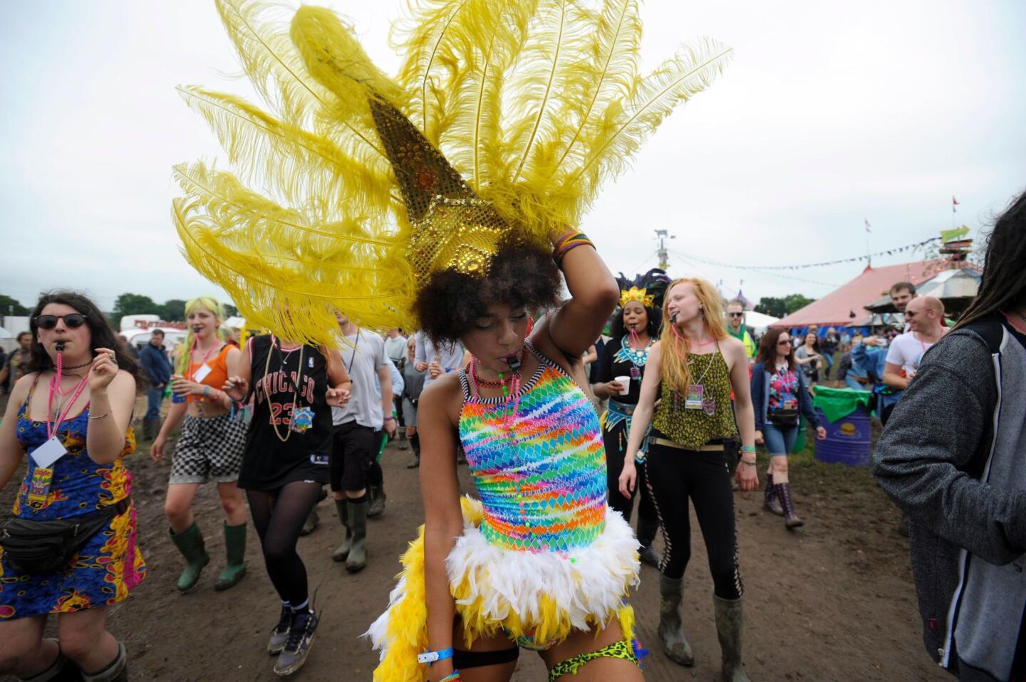 Festival goers make their way through the site at the Glastonbury Festival of Contemporary Performing Arts 2016.