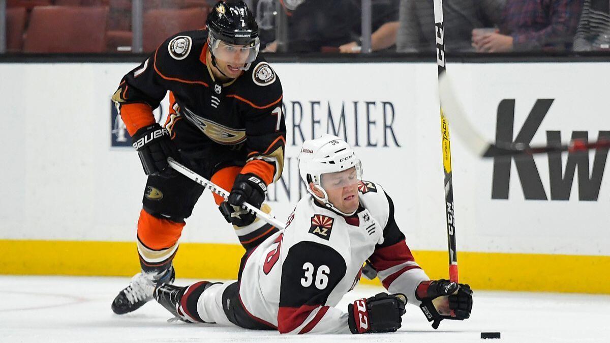 Arizona Coyotes right wing Christian Fischer, right falls as he reaches for the puck in front of Ducks center Andrew Cogliano during the third period of a preseason game Wednesday.