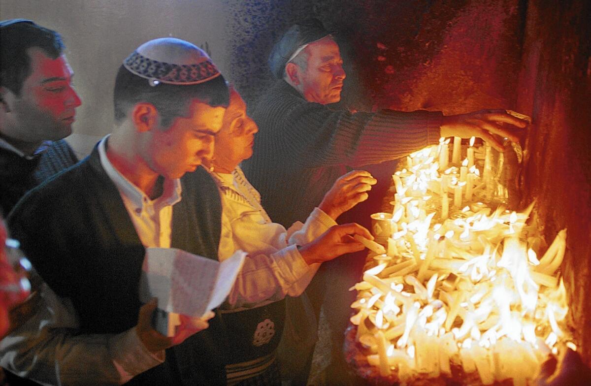 Jewish pilgrims light candles at the site of the tomb of Rabbi Yaakov Abuhatzeira in Egypt's Nile Delta in 1999. The annual festival honoring the 19th century rabbi once drew thousands.