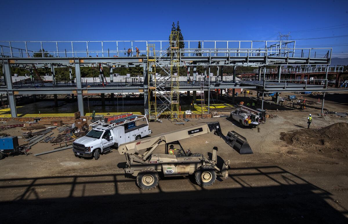 Equipment and trucks are seen at a construction site.