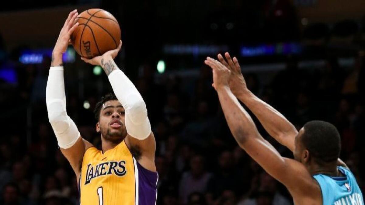 Lakers guard D’Angelo Russell (1) shoots over the Charlotte Hornets' Kemba Walker on Feb. 28.