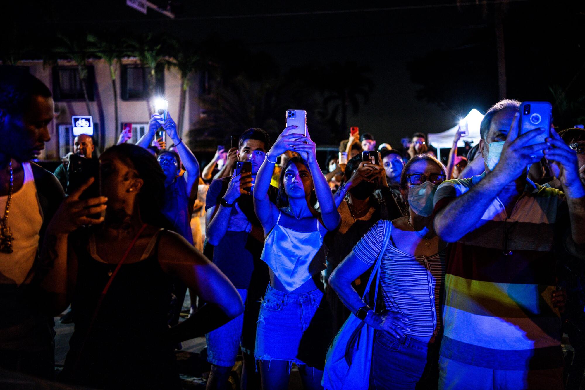 People watch as the rest of the Champlain South tower is demolished by a controlled explosion in Surfside, Fla.