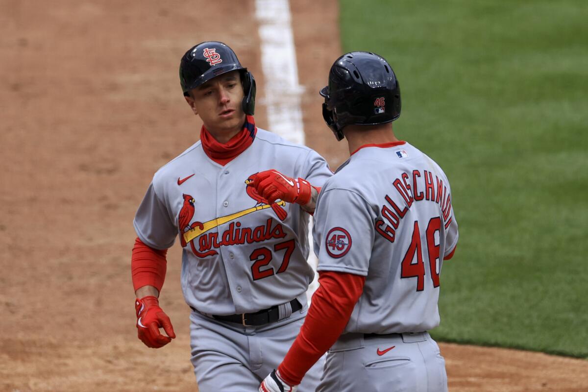 St. Louis Cardinals' Tyler O'Neill, left, celebrates hitting a two-run home run with teammate Paul Goldschmidt during the fourth inning of the baseball game against the Cincinnati Reds in Cincinnati, Thursday, April 1, 2021. (AP Photo/Aaron Doster)