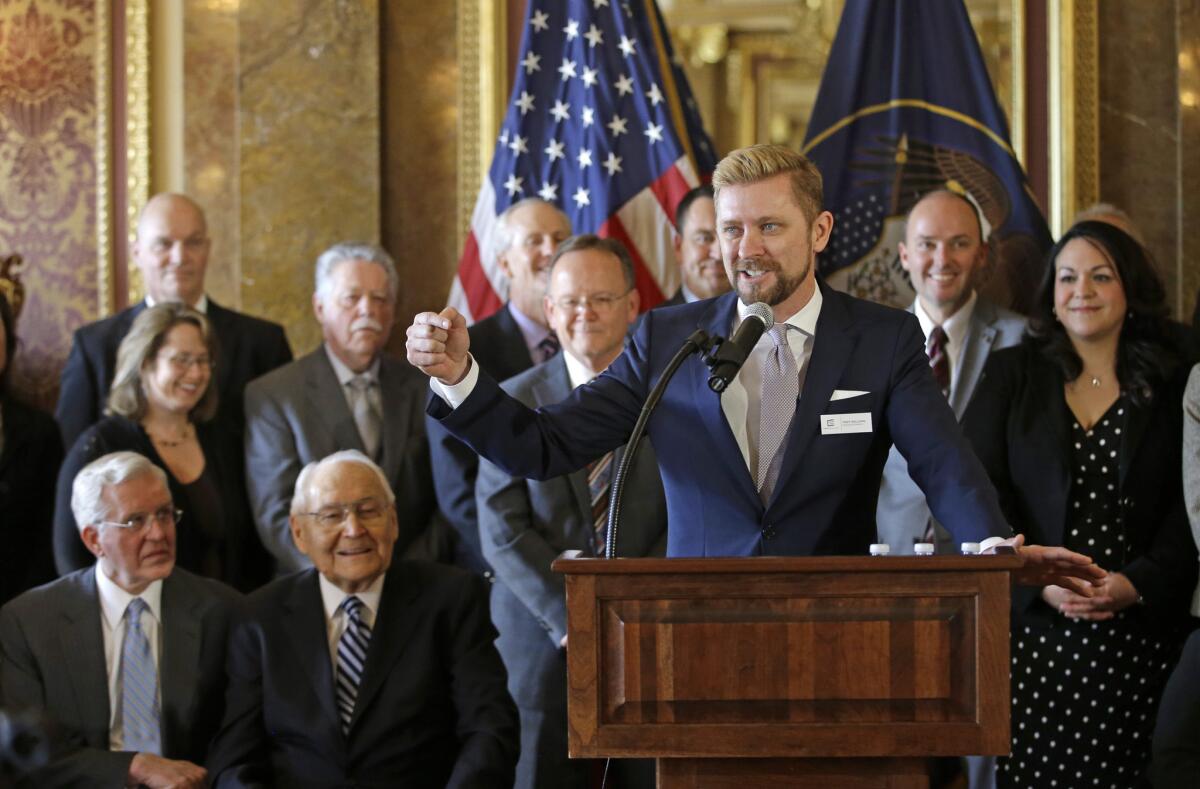 As Mormon leaders and others look on, Equality Utah Executive Director Troy Williams speaks at the Utah Capitol in Salt Lake City after the anti-discrimination bill was introduced this week in the state Senate. The bill was approved Friday on a 23-5 vote.