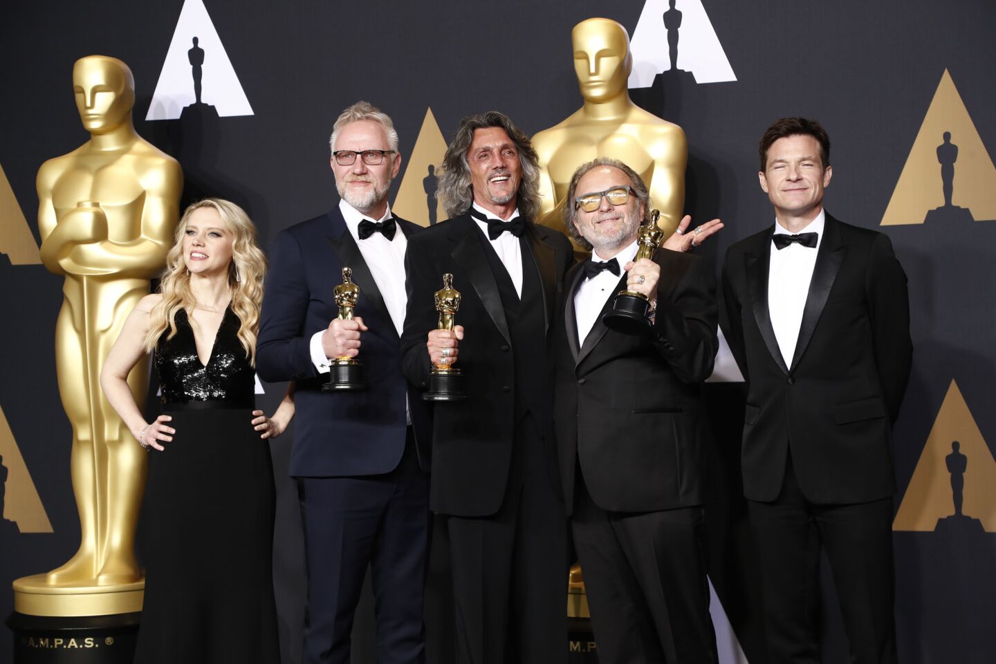 Presenters Kate McKinnon (left) and Jason Bateman (right) flank Christopher Nelson, Giorgio Gregorian and Alessandro Bertolazzi, who won Oscars for makeup and hairstyling.