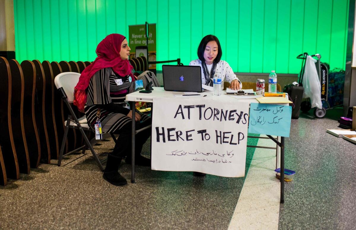 Volunteer attorneys sit in the arrivals area at LAX during a protest of the first travel ban executive order.
