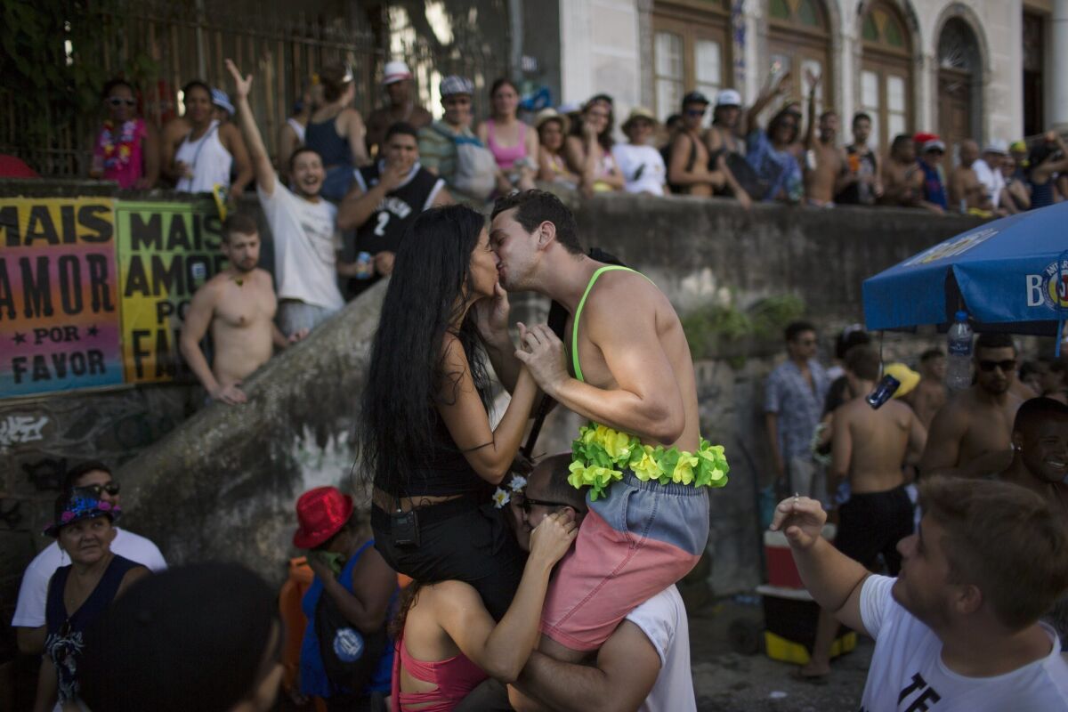 Couples kiss during Carnival celebrations in Rio de Janeiro.