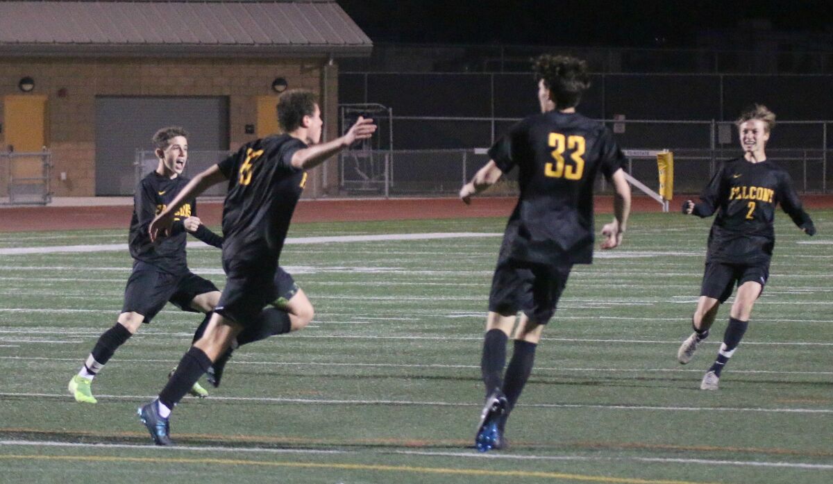 Teammates rush to congratulate Charlie Kosakoff (19) after he scored the game's first goal.