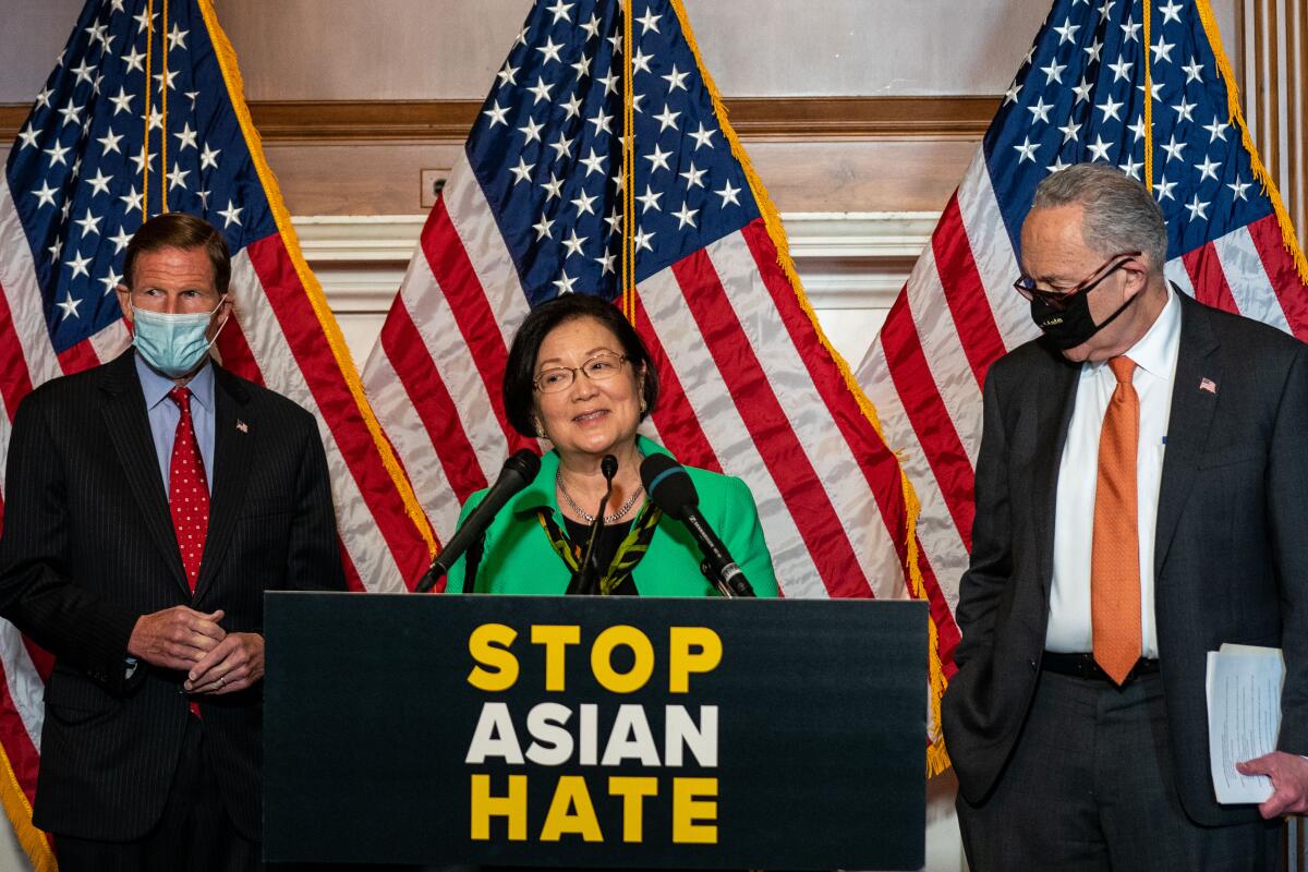 Sen. Mazie Hirono speaks at a news conference with Sen. Richard Blumenthal and Majority Leader Charles Schumer.
