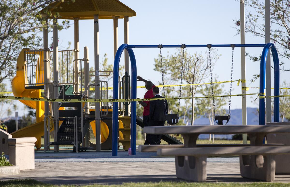 L.A. City Councilman Mitch Englander, right, inspects playground equipment with a park official after Holleigh Bernson Memorial Park was closed because an oily residue was found on the playground in Porter Ranch.