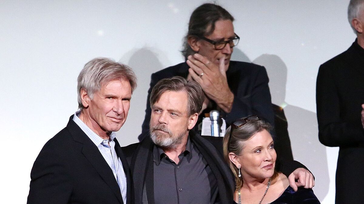 Harrison Ford, Mark Hamill, Carrie Fisher and Peter Mayhew (background) attend the Hollywood premiere of "Star Wars: The Force Awakens."
