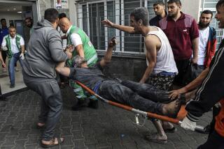 An injured Palestinian man is carried on a stretcher into the al-Shifa Hospital, following Israeli airstrikes on Gaza City, central Gaza Strip, Monday, Oct. 16, 2023. (AP Photo/Abed Khaled)