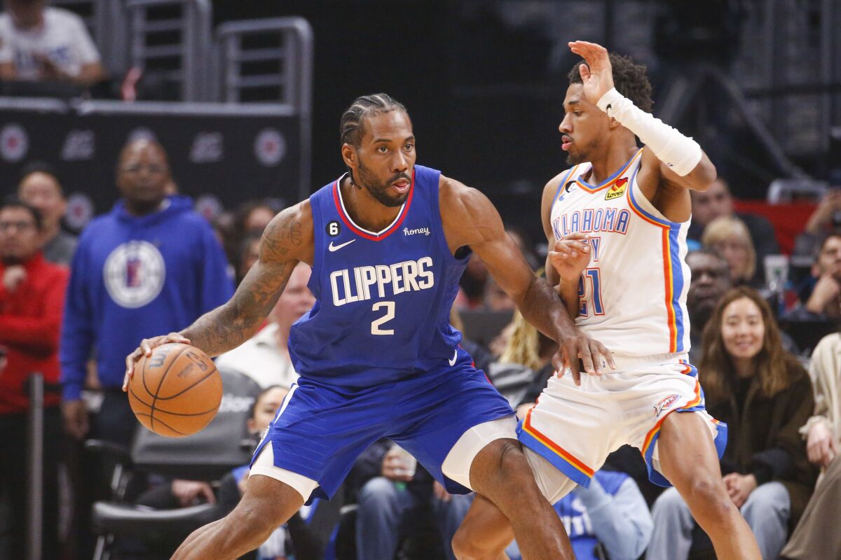 Clippers forward Kawhi Leonard is defended by Oklahoma City Thunder guard Aaron Wiggins.