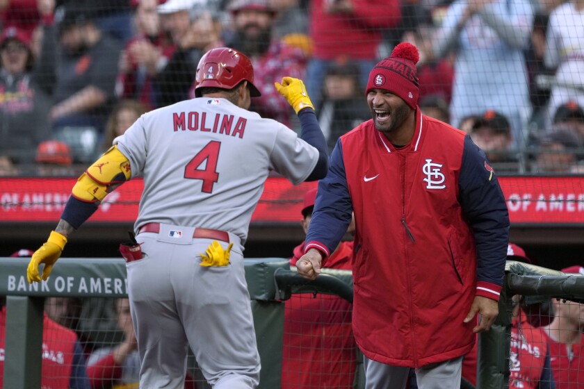 St. Louis Cardinals' Yadier Molina (4) is congratulated by Albert Pujols, right, after hitting a solo home run against the San Francisco Giants during the third inning of a baseball game Thursday, May 5, 2022, in San Francisco. (AP Photo/Tony Avelar)