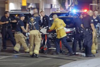 A man is transported by first responders following a stabbing in downtown Los Angeles near Skid Row on Aug. 8, 2024.