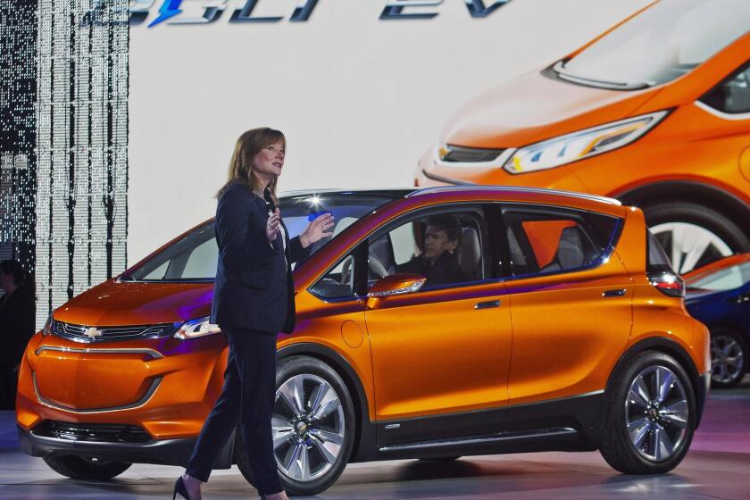 General Motors CEO Mary Barra and the Chevy Bolt. With a stated range of 238 miles, the all-electric car is expected to show up at dealerships in late December and January.
