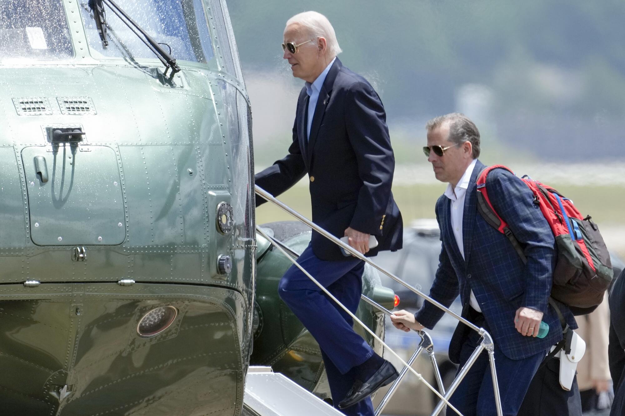 President Joe Biden boards Marine One with his son Hunter Biden as he leaves Andrews Air Force Base