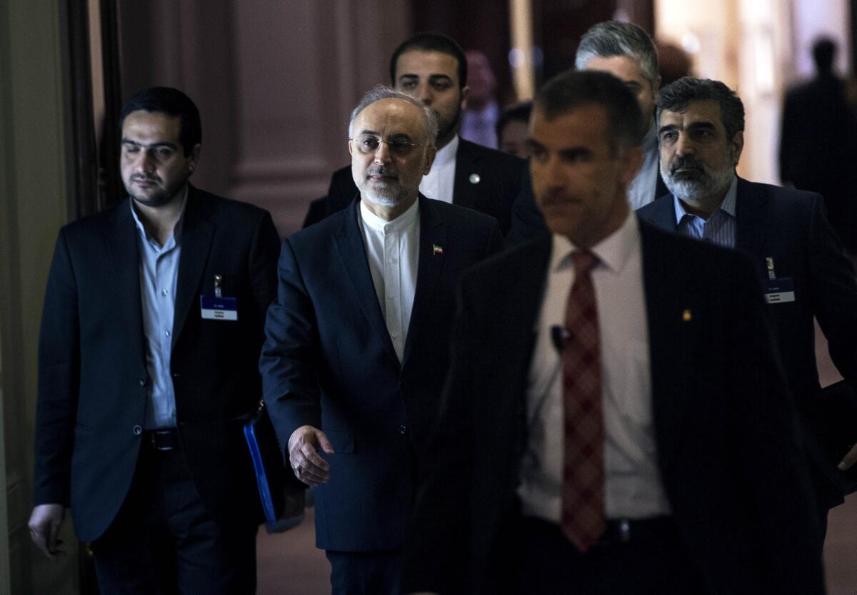 Head of Iranian Atomic Energy Organization Ali Akbar Salehi, center, walks after an extended round of talks on Iran's nuclear program at the Beau Rivage Palace Hotel in Lausanne, Switzerland.