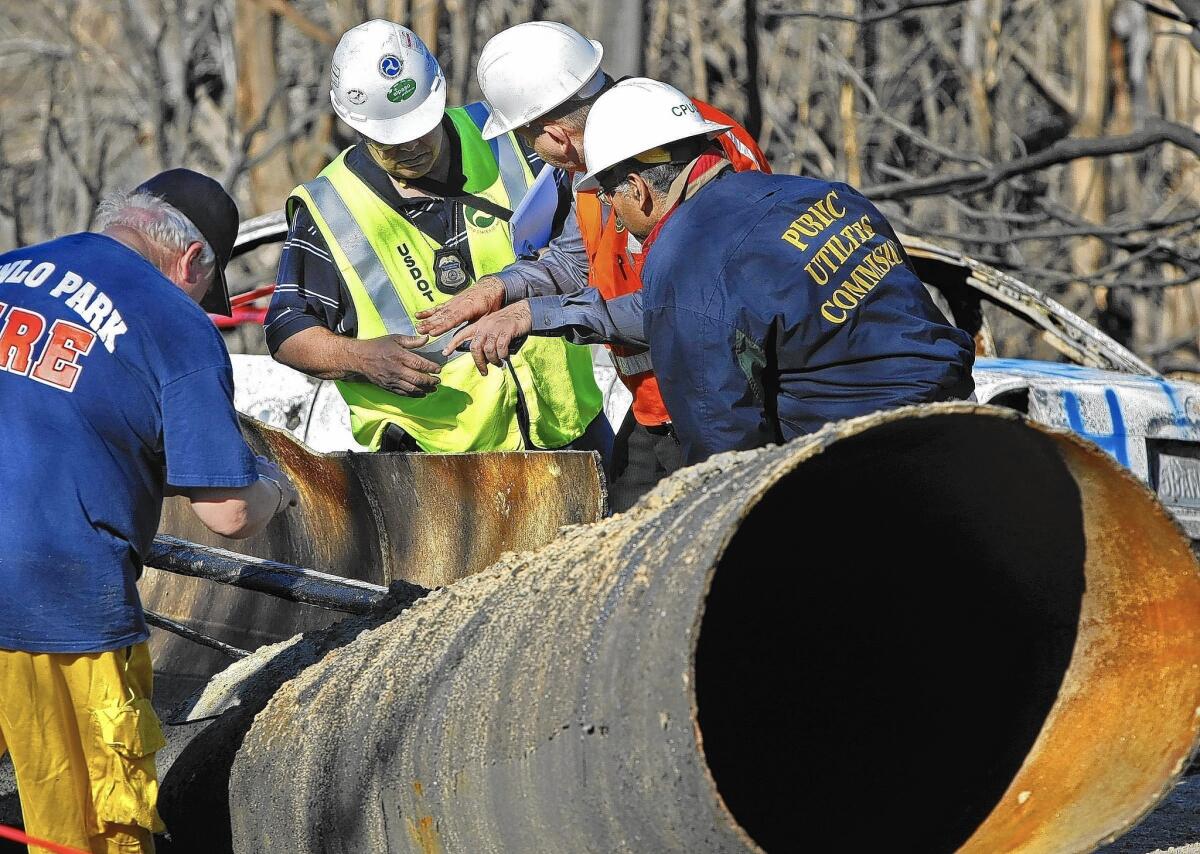 In 2010, inspectors from the U.S. Department of Transportation and the Public Utilities Commission listen to an inspector from Pacific Gas & Electric as they investigate a deadly natural gas pipeline explosion in San Bruno.