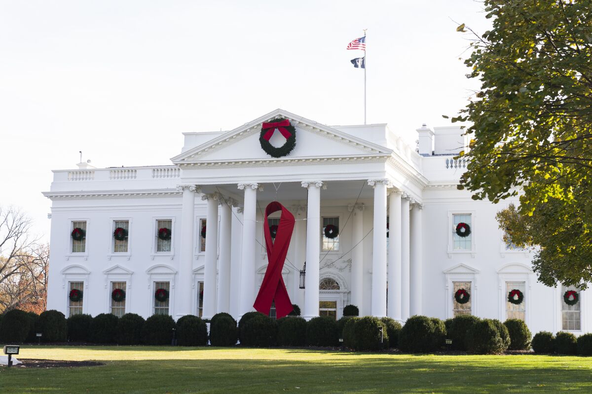 The North Portico of the White House is adorned with a huge red ribbon to commemorate the annual World AIDS Day