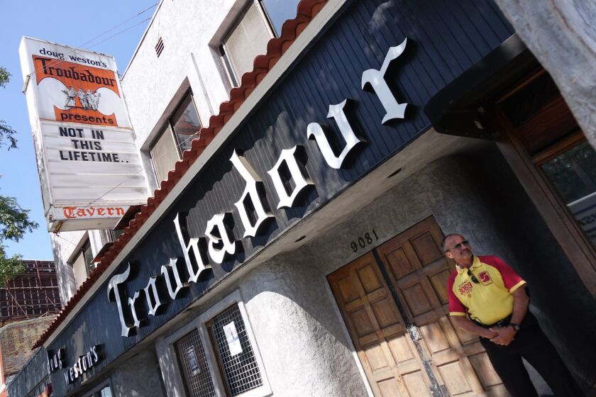 A guard stands outside the Troubadour where Guns N' Roses will perform tonight.