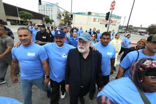 LOS ANGELES, CA - MAY 17, 2024 - Staff and program enrollees at Homeboy Industries, along with Father Greg Boyle, center, march to City Hall from Homeboy Industries for a ceremony marking Father Greg Boyle Day in Los Angeles on May 17, 2024. Father Greg was also honored for being awarded the Presidential Medal of Freedom by President Joe Biden. (Genaro Molina/Los Angeles Times)