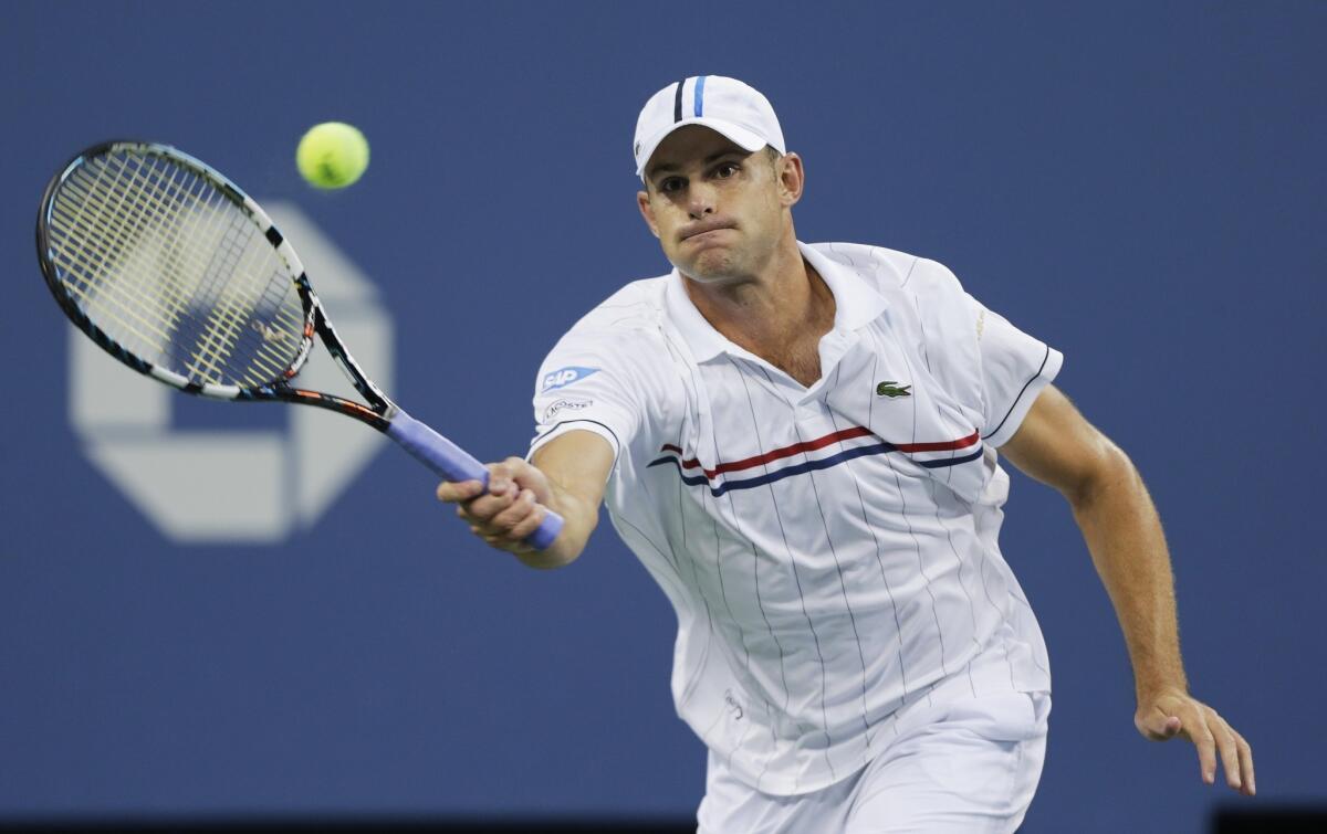 Andy Roddick returns a shot to Australia's Bernard Tomic in the third round of play at the 2012 US Open tennis tournament.