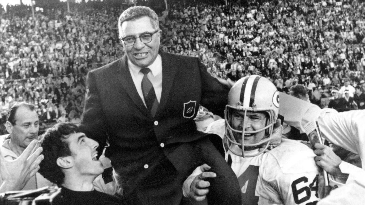 Green Bay Packers coach Vince Lombardi is carried off the field by players celebrating their victory over the Oakland Raiders in Super Bowl II on Jan. 14, 1968.