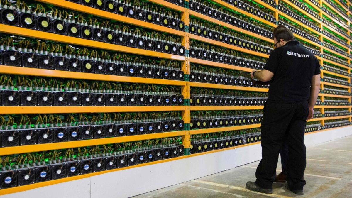 Technicians inspect bitcoin "mining" in Quebec. Since the end of 2017 bitcoin has been outperformed by the euro, despite Europe's central bank printing money, and the Turkish lira, despite that country's central bank being forced to keep interest rates inappropriately low.