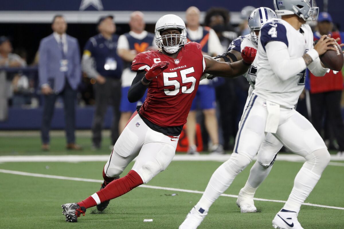 FILE - Arizona Cardinals outside linebacker Chandler Jones (55) rushes Dallas Cowboys quarterback Dak Prescott during the second half of an NFL football game in Arlington, Texas, Jan. 2, 2022. Jones bounced back from an injury-plagued 2020 season to record 10 1/2 sacks in 2021 for his seventh double-digit sack season. Only 12 players have had more seasons with at least 10 sacks and Jones' 107 1/2 for his career lead the NFL since he made his debut in 2012. (AP Photo/Roger Steinman, File)