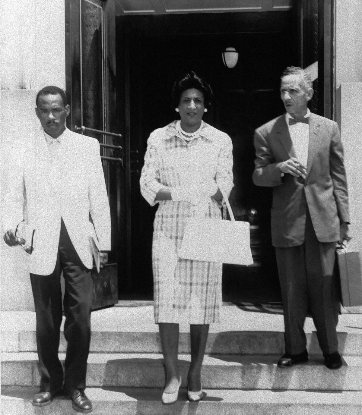 Constance Baker Motley, center, and another lawyer escort their client James Meredith, left, from a courthouse 