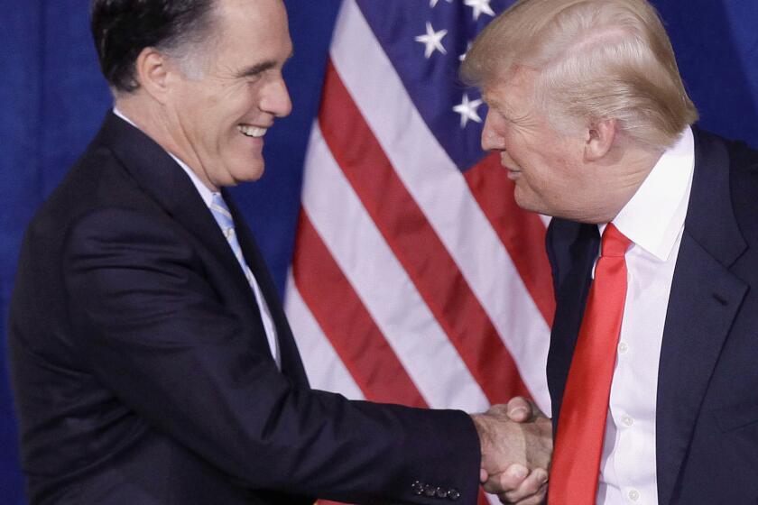 Donald Trump greets then-Republican presidential candidate Mitt Romney, left, at a 2012 news conference in Las Vegas during which he endorsed the former Massachusetts governor.