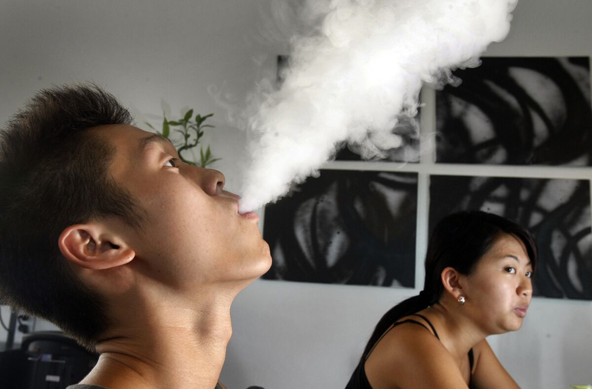 Brian Jung, 19, does vaping using an electronic cigarette at Aqua Vape in August 2013 in Temple City.
