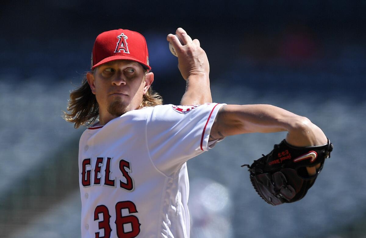 Jered Weaver of the Angels delivers into the seventh inning on the way to beating the Texas Rangers.