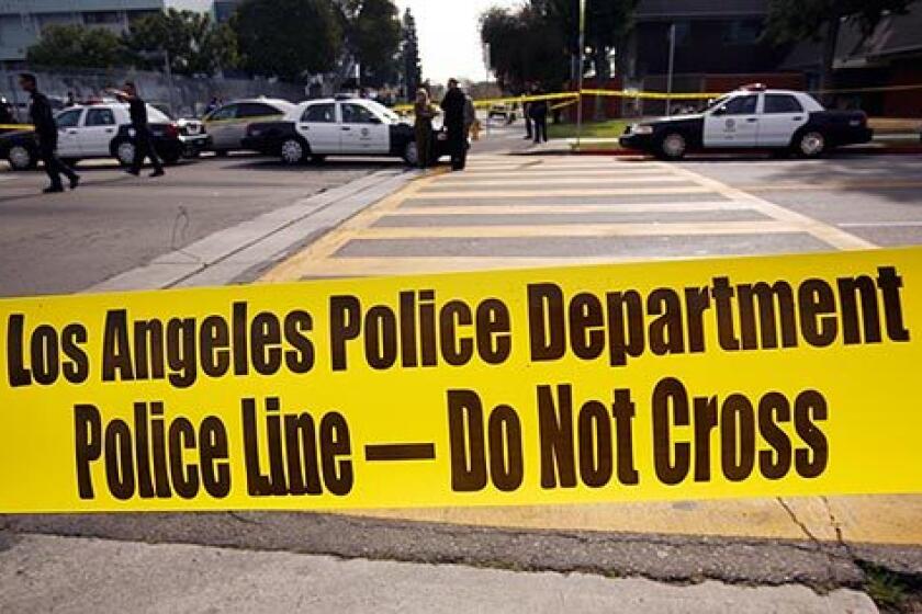Police tape marks the area where a 16-year-old Locke High School student was shot in front of the South L.A. campus Monday morning. Police are looking for a 17-year-old who walked up to the student and shot him in the upper body before fleeing. The suspect was described as Latino, about 5 feet 6 and 150 pounds, wearing a gray hoodie sweatshirt and tan pants, said Officer Sara Faden, an LAPD spokeswoman.