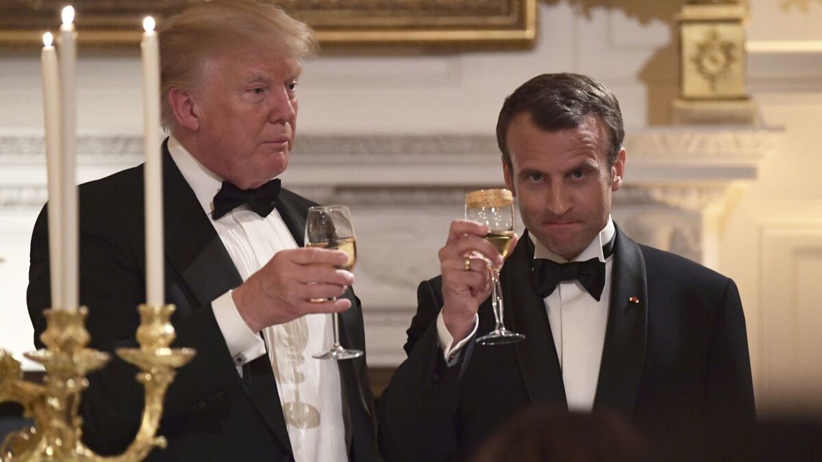 President Trump and French President Emmanuel Macron share a toast during the state dinner at the White House.