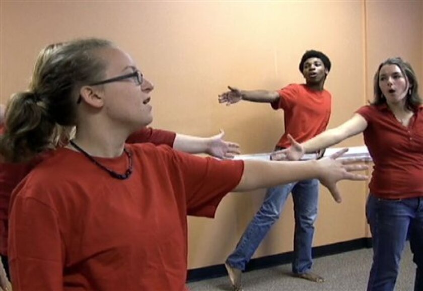 This Aug. 20, 2010 photo made from video shows, from left to right, Samantha Savery, 14, of Marshville, N.C., Malik Jefferson, 15, of Charlotte, N.C., and Ashley Martin, 17, of Mint Hill, N.C., as they participate in Charlotte Academy of Music's Glee Camp. The Charlotte Academy of Music's first Glee Camp in June sparked so much interest from students eager to replicate what they saw on the hit musical TV show, the academy added a second camp, plus created a Glee Club that started practicing last week. (AP Photo/Seanna Adcox)
