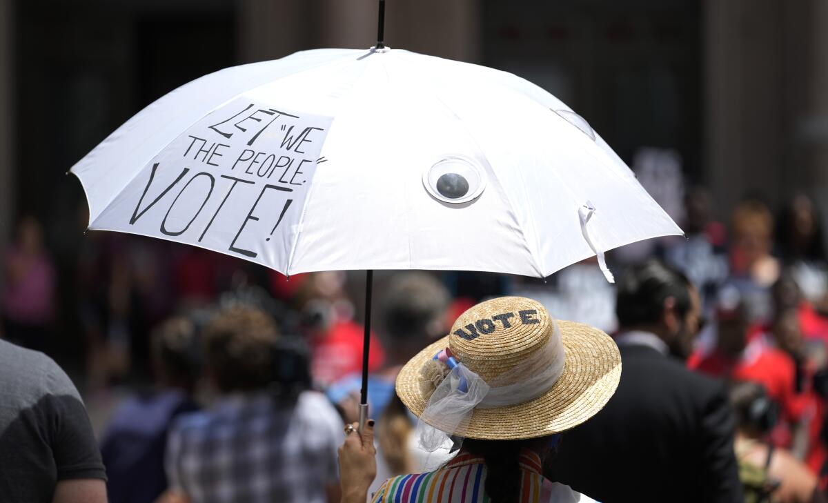 Jessica Ramirez joins a rally to support voter rights on the steps of the Texas Capitol, Thursday, July 8, 2021, in Austin, Texas. The Texas Legislature began a special session Thursday. (AP Photo/Eric Gay)