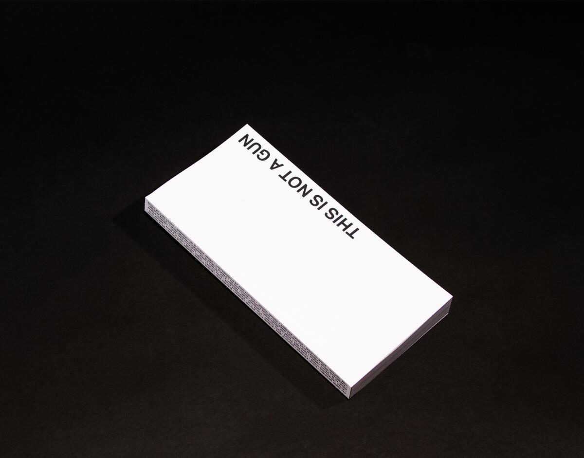 The book "This Is Not a Gun" — produced all in white — is shown against a stark black background.