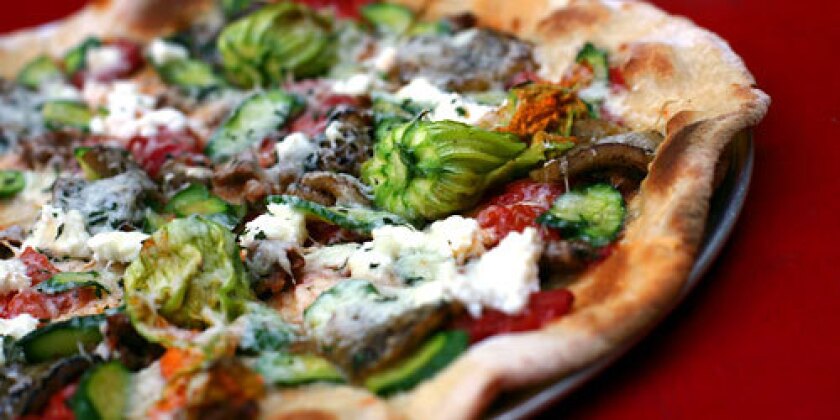 Pizzas are a specialty of the house at Gjelina in Venice. The lamb sausage, zucchini, eggplant, ricotta and pecorino pizza is one of the most popular.